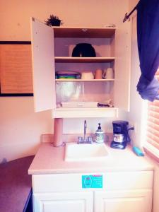 a kitchen counter with a sink in a cupboard at Red Rox Casita - WAY more than just a place to spend the night! in Ivins