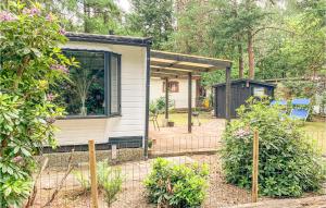 a tiny house in a garden with a patio at Amazing Caravan In Hattemerbroek With Wifi And 1 Bedrooms in Hattemerbroek