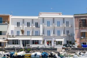 a large white building with boats in a harbor at Baia Flegrea Meublè in Bacoli