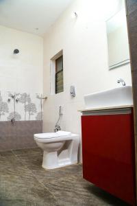 a bathroom with a toilet and a sink and a shower at M aples Jacks Place in Cavelossim