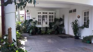 a porch of a house with a lot of plants at Jal,Min Homestay in Kandy