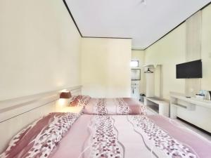Ein Bett oder Betten in einem Zimmer der Unterkunft Bromo Permai 1
