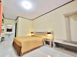 Ein Bett oder Betten in einem Zimmer der Unterkunft Bromo Permai 1