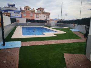 a swimming pool on the roof of a house at Casa, sol y playa 365 días!! in San Juan de los Terreros