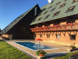 a large building with a fountain in front of it at Apartmán 206 Žalý in Benecko