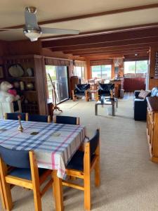 a room with a table and chairs and a living room at Apollo Stay in Apollo Bay