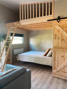 a bedroom with a bunk bed with a ladder at Field View Cabin in Örebro