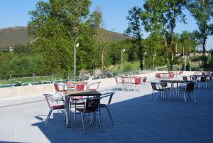 a group of tables and chairs on a patio at Hotel Parrilla el Zangano in Boal