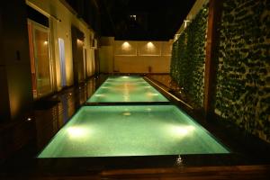 a large swimming pool with lights in a building at Kalki Hotel in Port Blair +11 photos