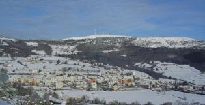 a town in the snow on a snowy mountain at Hotel Parrilla el Zangano in Boal