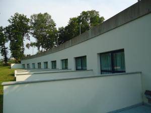 a white building with windows on the side of it at Hotel Parrilla el Zangano in Boal