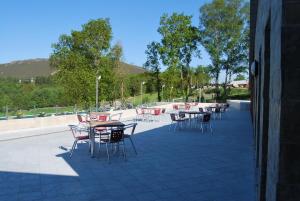 a group of tables and chairs on a patio at Hotel Parrilla el Zangano in Boal