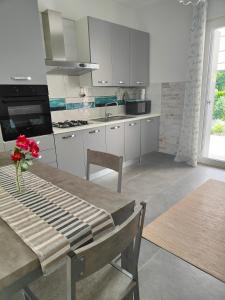 kuchnia ze stołem z wazonem kwiatów w obiekcie Villa Marianna Garda Lake w mieście Peschiera del Garda