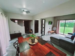 a living room with a table and a couch at Volcano view house la Fortuna in Fortuna
