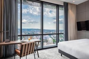 A bed or beds in a room at Pullman Tbilisi Axis Towers