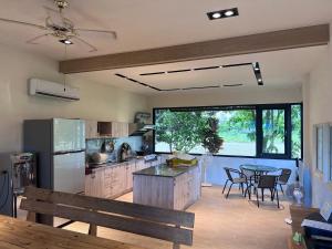 a large kitchen with a table and a dining room at Futian B&B in Ji'an