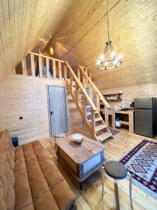 a living room with a large couch and a staircase at mood villa Kazbegi in Kazbegi +62 photos