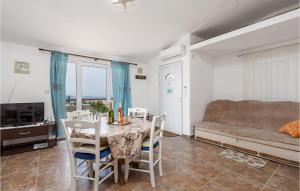a living room with a table and a couch at Amazing Apartment In Stinica With Kitchen in Stinica