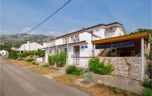a white house on the side of a road at Amazing Apartment In Stinica With Kitchen in Stinica