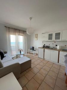 a living room with a large bed and a kitchen at Apartment Frina II, Island Hvar in Jelsa
