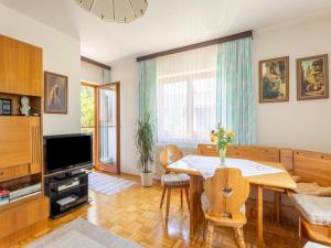a living room with a dining table and a television at Tranquil Holiday Home in Aywaille with bubble bath in Seeboden