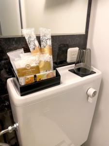 a box of snacks on top of a toilet in a bathroom at Hotel Prezier Akihabara - Vacation STAY 21812v in Tokyo