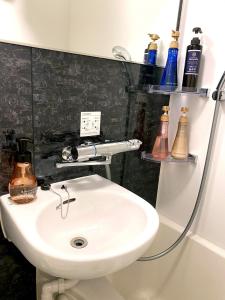 a bathroom with a white sink and some bottles at Hotel Prezier Akihabara - Vacation STAY 21812v in Tokyo