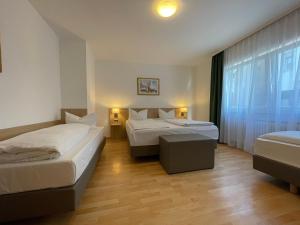 Letto o letti in una camera di Hafner Hotel Apartment Self Check-In Anytime