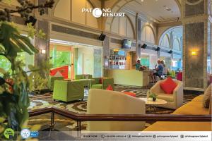 a lobby of a hotel with colorful chairs and tables at Patong Resort Hotel - SHA Extra Plus in Patong Beach