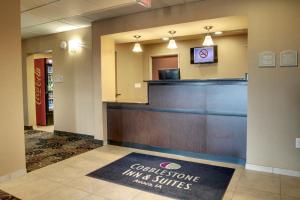 a lobby with a reception desk in a hotel at Cobblestone Inn & Suites - Avoca in Avoca