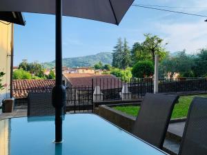 a table with chairs and an umbrella on a patio at Casa Luna - Private Cottage -Exclusive Private Garden in Barga