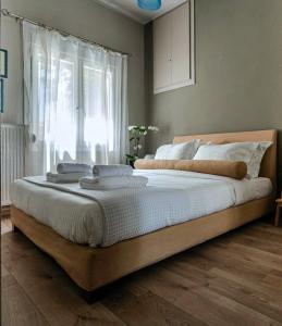 a large bed in a bedroom with a window at The Beetle House in Volos