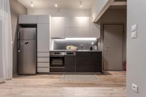 a kitchen with a sink and a refrigerator at The Beetle House in Volos