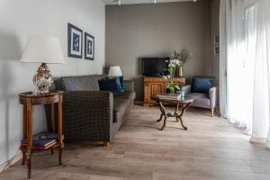 a living room with a couch and a tv at The Beetle House in Volos