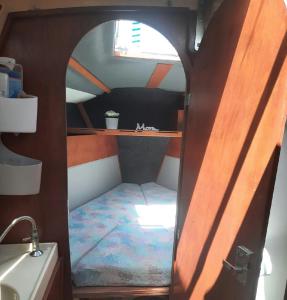 um pequeno quarto com uma cama no meio de um barco em Voilier logement spacieux à louer au port - Gruissan Plage - 11 Aude em Gruissan