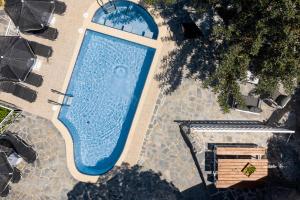 an overhead view of a large swimming pool at Kefali Villa, eco tourism experience, By ThinkVilla in Atsipádhes