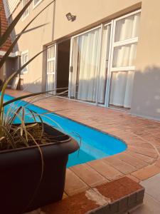 a swimming pool in front of a house at Bella Lux Villa in Durban