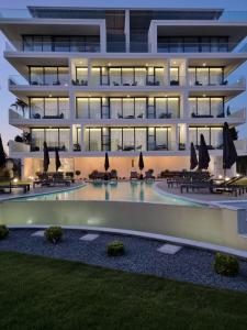 un edificio de apartamentos con piscina por la noche en The Palmiers en Pafos