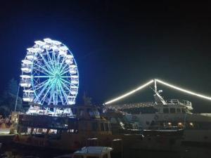a ferris wheel is lit up at night at Romantic Guesthouse Porto close to Sandy beach in Crikvenica