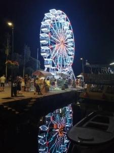 a ferris wheel at a carnival at night at Romantic Guesthouse Porto close to Sandy beach in Crikvenica