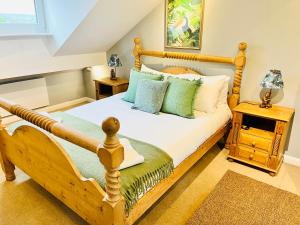 a bedroom with a wooden bed and a night stand at Burley Apartment in Burley in Wharfedale