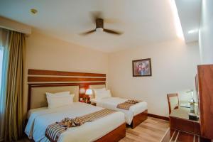 A bed or beds in a room at Minh Toan Athena Hotel
