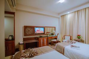 A bed or beds in a room at Minh Toan Athena Hotel