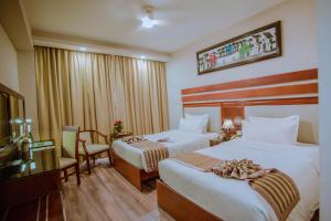 A bed or beds in a room at Minh Toan Athena Hotel