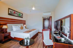 A bed or beds in a room at Minh Toan Athena Hotel