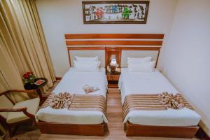 A bed or beds in a room at Minh Toan Athena Hotel