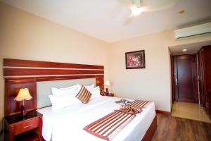 A bed or beds in a room at Minh Toan Athena Hotel