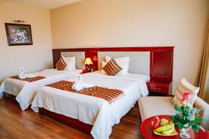 A bed or beds in a room at Minh Toan Athena Hotel
