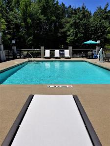 a swimming pool with a sign in front of it at Holiday Inn Express Apex - Raleigh, an IHG Hotel in Apex