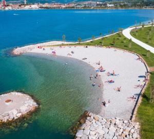a group of people on a beach in the water at Apartment Kp with parking in Koper